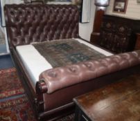 A Ralph Lauren sleigh bed upholstered in brown leather W.204cm