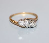 An 18ct and plat, three stone diamond crossover ring, size M.