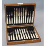 A cased set of twelve pairs of plated dessert knives and forks, with mother of pearl handles