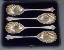 A cased set of four Victorian silver serving spoons, London, 1895 and a cased set of twelve pairs of