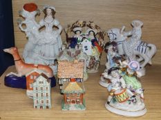 A small collection of Staffordshire figures, groups and cottages, two Sitzendorf figural groups, a