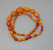 A single strand graduated oval amber bead necklace, gross weight, 60 grams, 66cm.