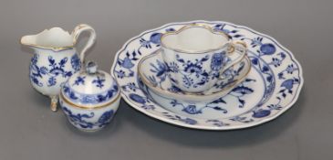 A Meissen blue onion pattern cup, saucer, cream jug, sugar bowl and cover