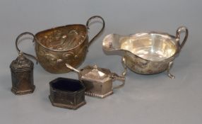 A George V silver three piece cruet set by Walker & Hall, a silver sauceboat and silver sugar bowl.