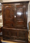 A mid 18th century walnut press cupboard, with two panelled doors and two base drawers, on stile