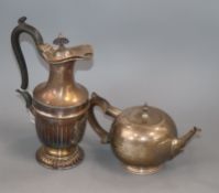An Edwardian demi fluted hot water pot and a Scottish planished silver bullet shaped teapot,