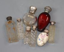 Eight assorted silver/white metal mounted scent bottles, including ruby glass and porcelain, largest