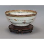 A late 18th century Chinese export polychrome bowl, decorated with a band of ribbon and flowers in