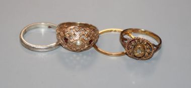 A yellow metal and diamond set ring, a 22ct gold band, a 9ct ring and a silver ring.