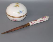 A small Meissen circular box painted with flowers and a porcelain handled knife