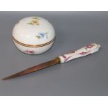 A small Meissen circular box painted with flowers and a porcelain handled knife