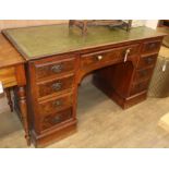 An early 20th century figured walnut kneehole desk W.135cm