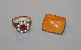 A Victorian yellow metal and carnelian? set brooch, carved with a seated dog and winged heart and