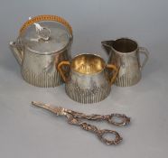 A pair of modern silver grape shears and a silver plated travelling teaset.