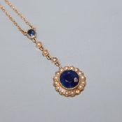 An early 20th century yellow metal ,sapphire and seed pearl set drop flowerhead pendant necklace (