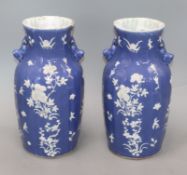 A pair of 19th century Chinese blue ground vases, with white floral decoration