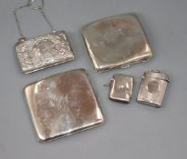 Two silver cigarette cases, two silver vesta cases and a silver mounted purse.