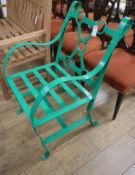 A green painted wrought iron garden seat