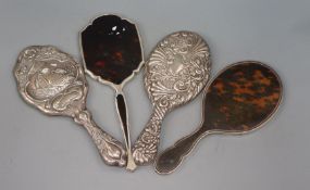 Four assorted silver/white metal mounted hand mirrors including Edwardian.