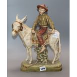 A Royal Dux model of a youth riding a donkey