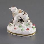 A Staffordshire porcelain group of two kittens playing, c.1835-50, on an oval base encrusted with
