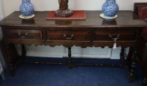 A James II oak dresser, the moulded projecting top over three drawers with fielded fronts above