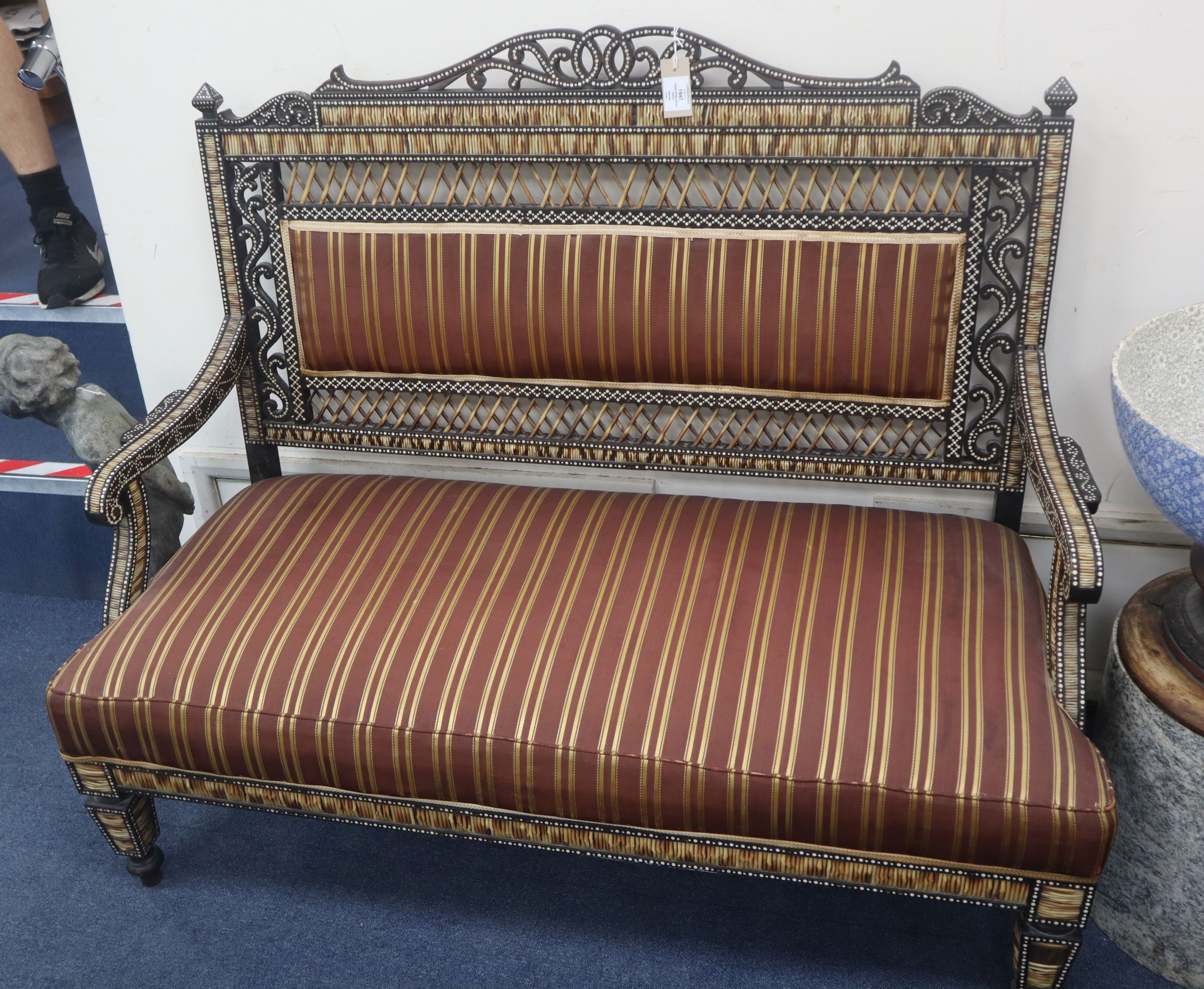 A late 19th/early 20th century ebony and porcupine quill sofa by H Don Carolis and Sons, Colombo W.