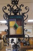 A wrought iron stained glass hall lantern