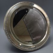 A George V silver mounted circular easel mirror, by Mappin & Webb, London, 1910, diameter 36.5cm.