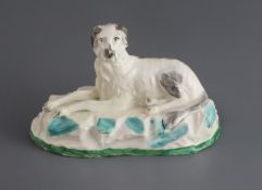 A Madeley porcelain figure of a recumbent Saluki, c.1830, L. 12.7cmProvenance - The Dennis G. Rice