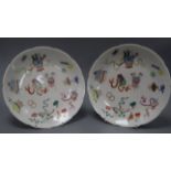 A pair of 19th century Chinese famille rose 'hundred antique' dishes diameter 24cm