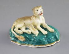 A Staffordshire porcelain group of a lioness and cub, c.1830-45, on a green rockwork base, L.