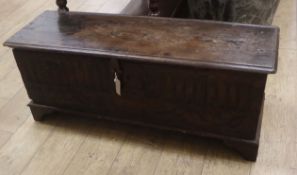 An early 18th century oak coffer, the front carved with vertical flutes and dated 1714 W.114cm