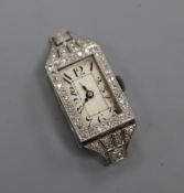 A lady's white metal (stamped plat) and diamond set cocktail watch (a.f.).