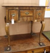 A George III oak and walnut lowboy, fitted three drawers on cabriole legs and horse hoof feet W.