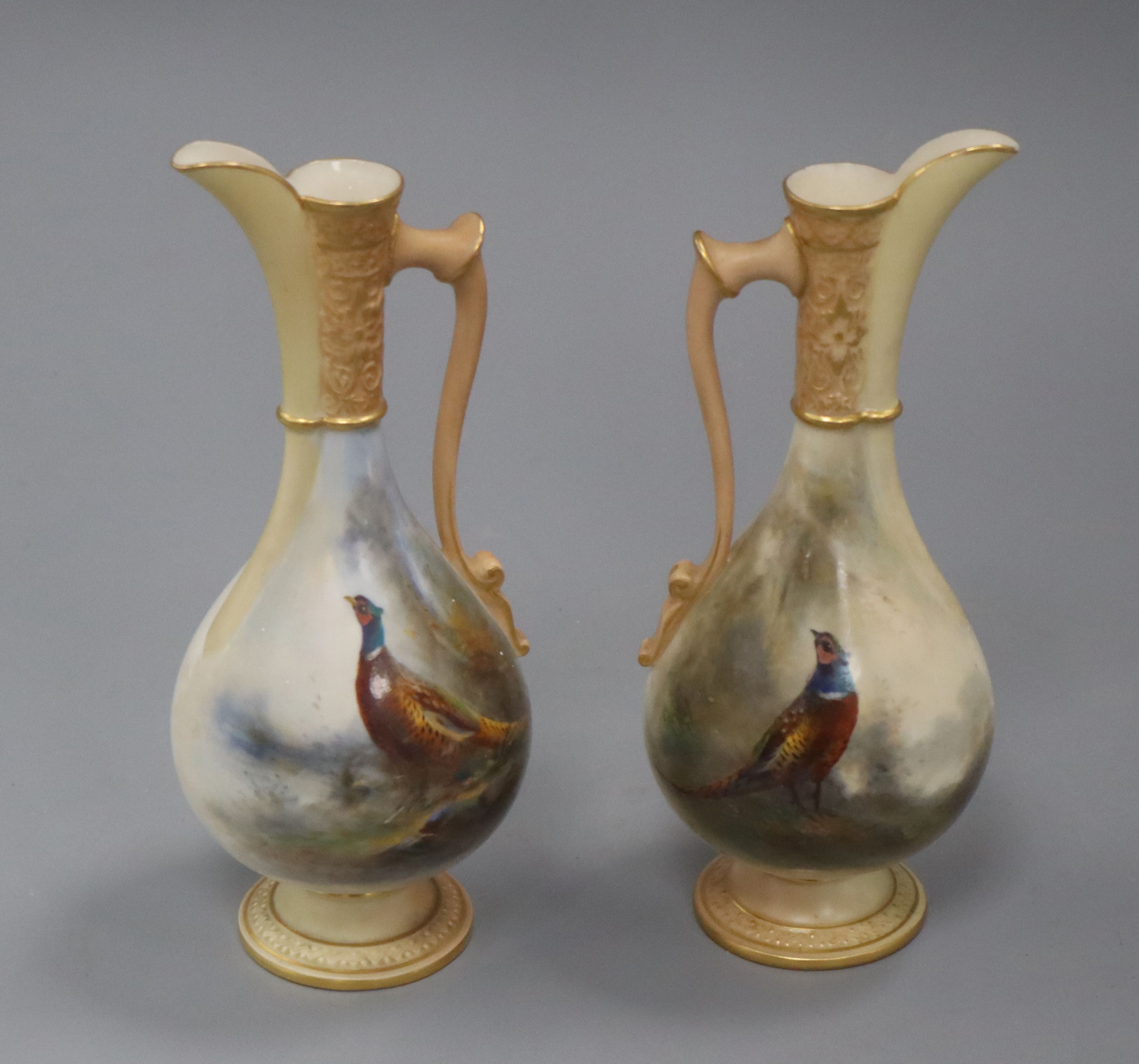James Shinton for Royal Worcester. A pair of ewers height 18cm