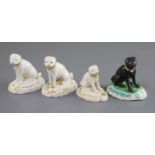 Four Derby porcelain figures of seated pug dogs, c.1830, three in gilt and white and one in black on