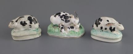 A Staffordshire porcelain group of a rabbit and young and two similar figures of rabbits, c. 1830-