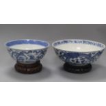 Two 19th century Chinese blue and white 'dragon' bowls, Kangxi mark, on wooden stands diameter 25.