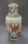 A Chinese famille verte vase, with twin elephant handles and decorated with shubunkins, restored