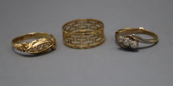 An 18ct gold five-stone diamond ring, a similar three-stone ring and a Greek Key patterned ring (