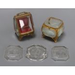 Two French gilt metal and glass trinket boxes and three intaglio glass dishes