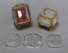 Two French gilt metal and glass trinket boxes and three intaglio glass dishes