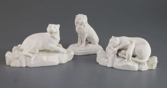 A pair of Staffordshire biscuit porcelain figures of leopards and a similar figure of a lion, c.