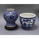 A Chinese blue and white jardiniere, Kangxi mark, and a similar vase, 20.5cm with hardwood stand