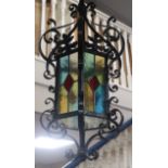 A wrought iron stained glass hexagonal hall lantern