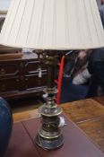 A pair of large bronzed metal three branch table lamps