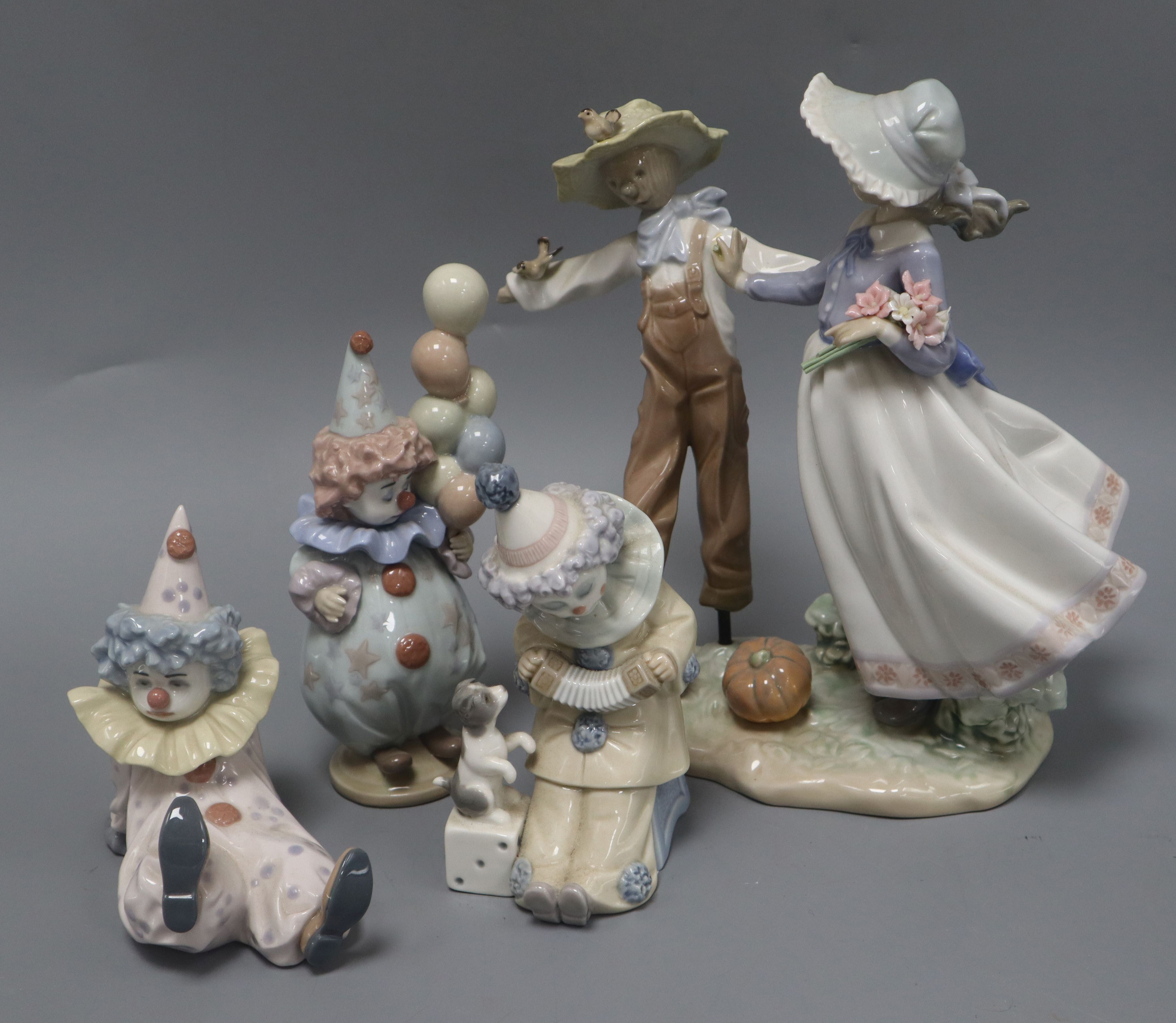 A Lladro group and three clowns