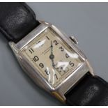 A gentleman's 1930's silver manual wind wrist watch, retailed by J.W. Benson, on leather strap in