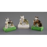 Three Staffordshire porcelain groups of a cat and kitten, c.1835-50, each with tortoiseshell